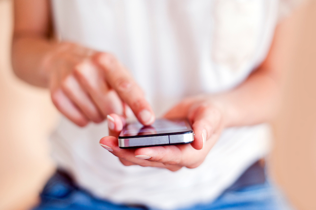 Young woman using a touchscreen smartphone.