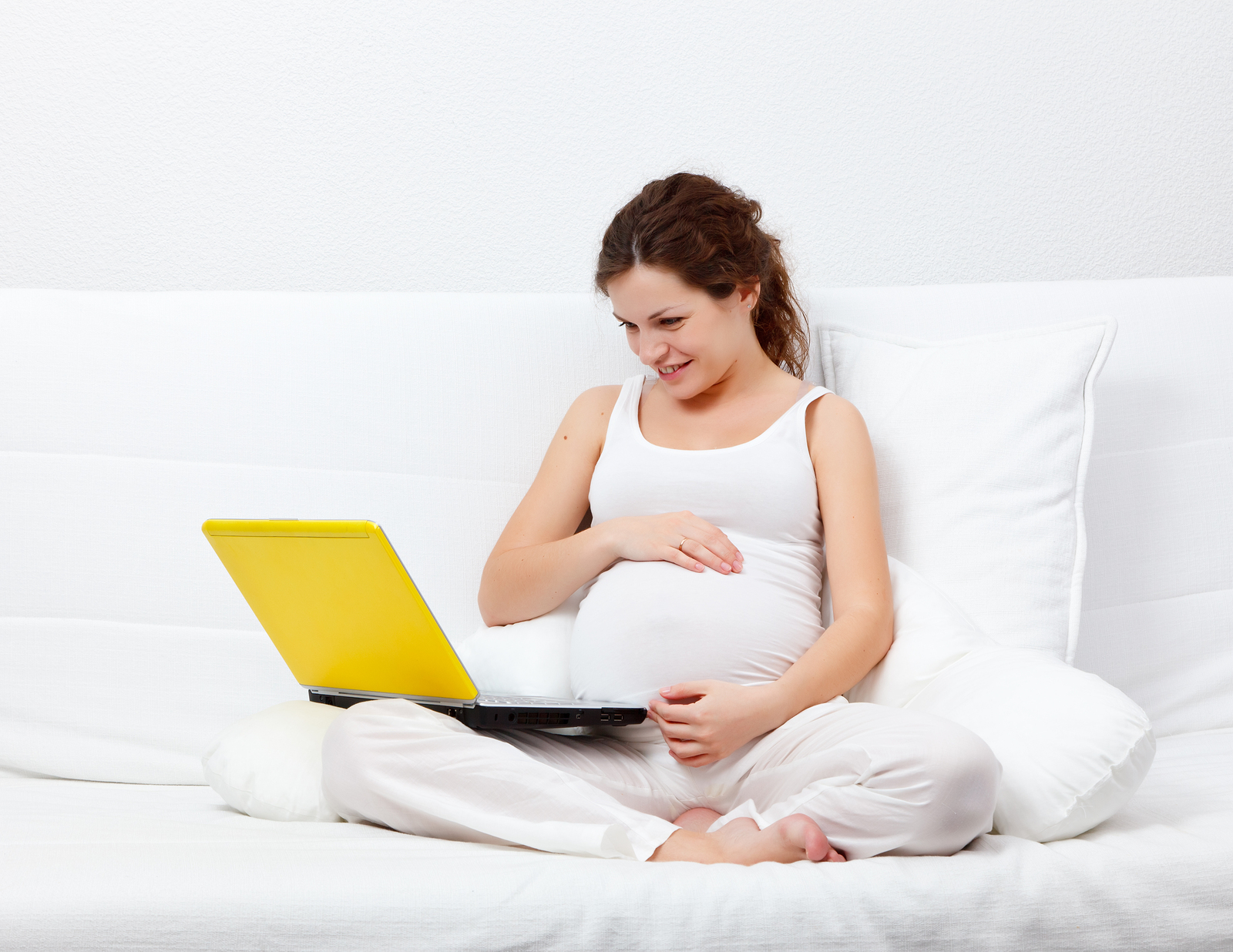 Young pregnant woman with a laptop